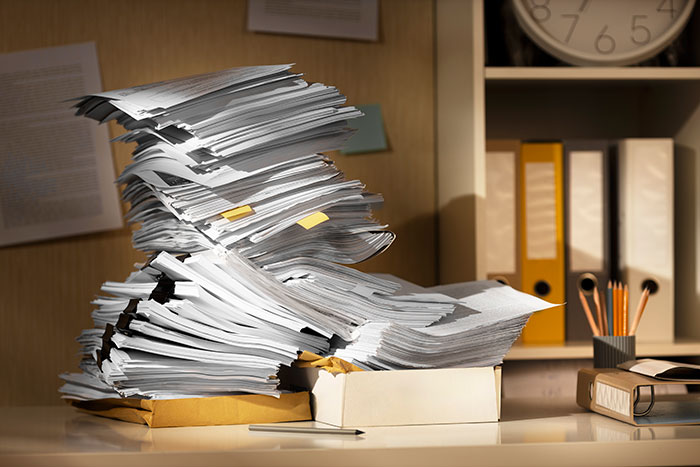 Stack of papers on a desk, surrounded by folders and stationery, possibly related to infidelity accusations. Stack of papers on a desk, surrounded by folders and stationery, possibly related to infidelity accusations.