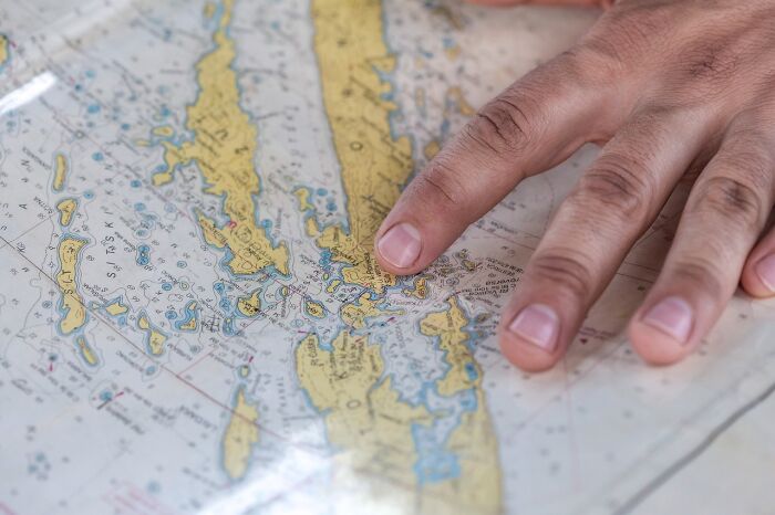 Hand pointing at a detailed map, ready to challenge your internal fact checker.
