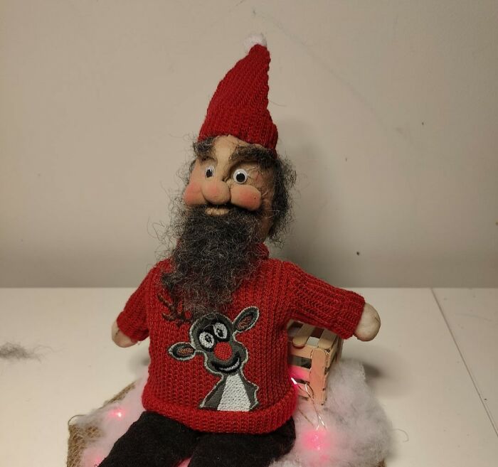 Unusual Santa doll with a red sweater.