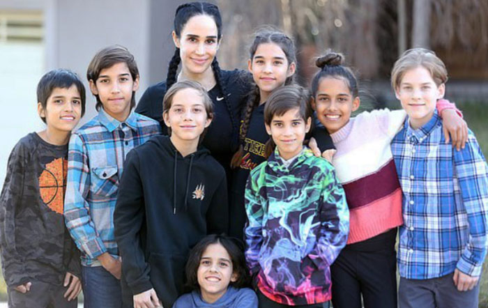 Octomom Nadya Suleman smiling with her octuplets, posing outdoors. Octomom Nadya Suleman smiling with her octuplets, posing outdoors.