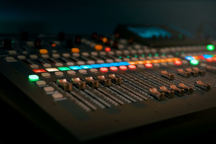 Audio mixing console with illuminated faders and buttons, related to lifetime supply winners sharing experiences.