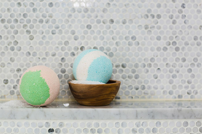 Colorful bath bombs on a marble shelf, reflecting a birthday gift theme.