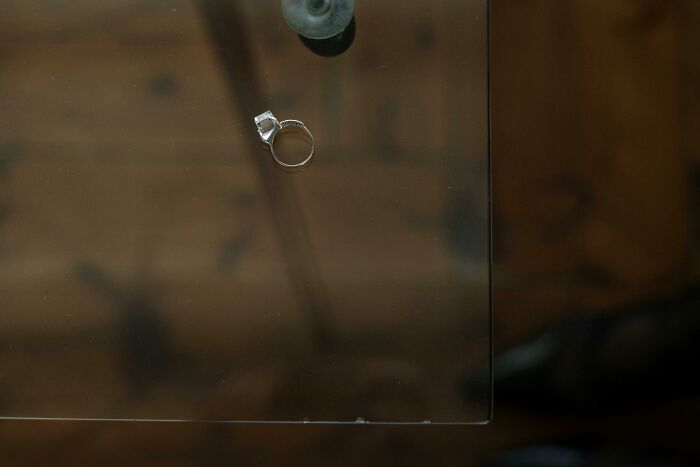 A ring on a glass table symbolizing love and forgiveness consequences in relationships.