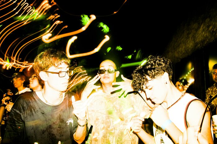 Teens in the 2000s at a party with neon lights, capturing youthful energy and nostalgia.