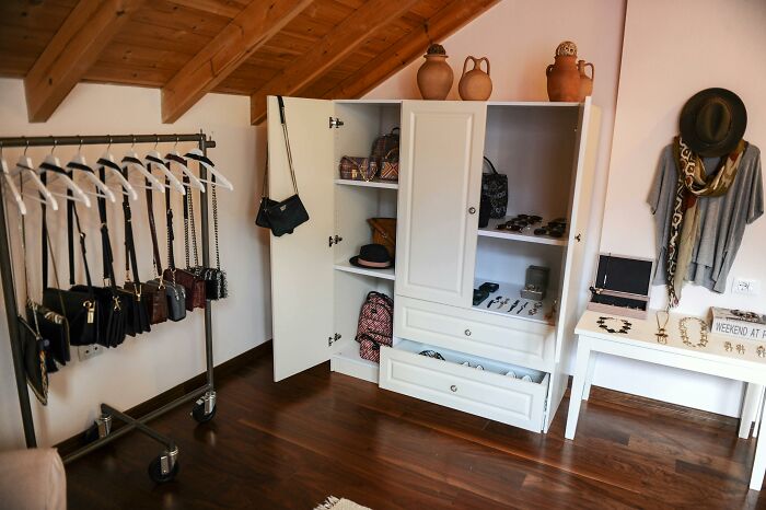 Wardrobe with organized bags and accessories.