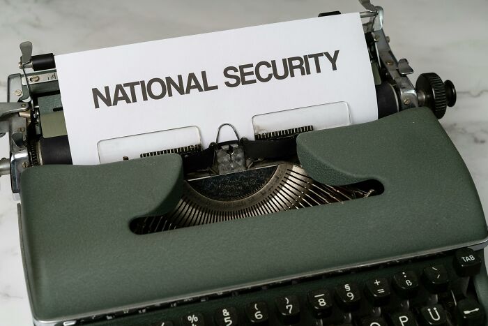 A typewriter with a sheet labeled "National Security," hinting at controversial conspiracy theories.