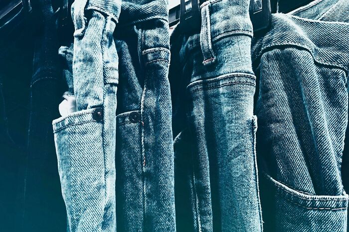 Jeans from the 2000s hanging on a rack, representing teen fashion memory lane.