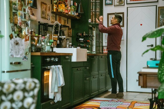 Person in a cozy kitchen, opting for personal style over trendy decor choices.