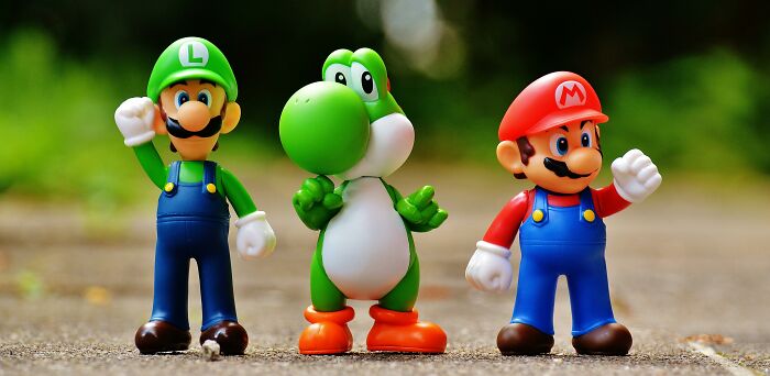 Three toy figures from a popular video game series standing on a path, used as a metaphor for "the weird ones" in school.