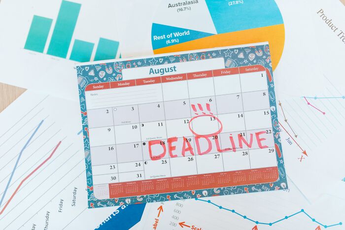 Calendar with "DEADLINE" written, lying on various charts, illustrating affordable ways to make life easier.