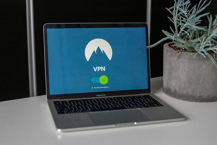 Laptop displaying VPN connection next to a potted plant, showcasing ways to make life easier.