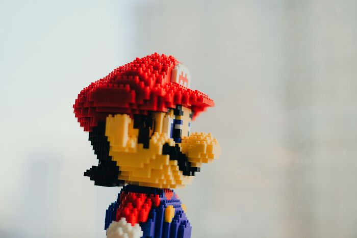 Lego figure of a character with a red hat and overalls, illustrating topics of kids being labeled as weird in school.