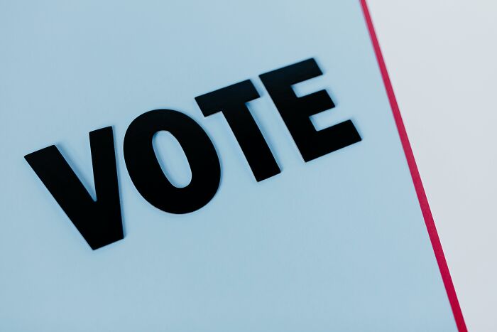 The word "VOTE" in bold black letters on a light background, highlighting outdated financial stereotypes.