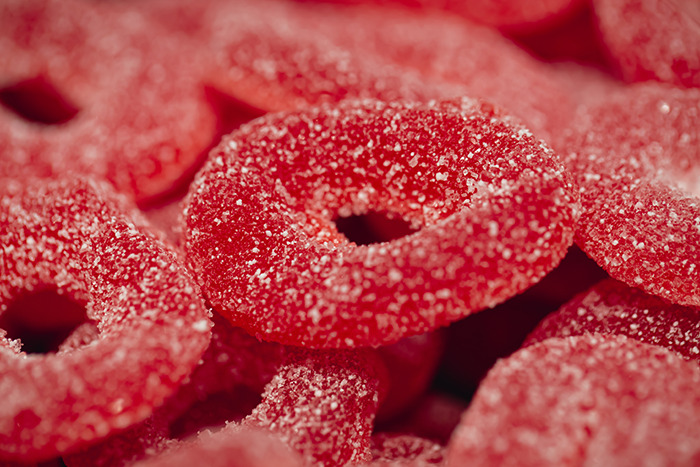 Red candy rings made with Red Dye No. 3, highlighted for their artificial color and food safety concerns.