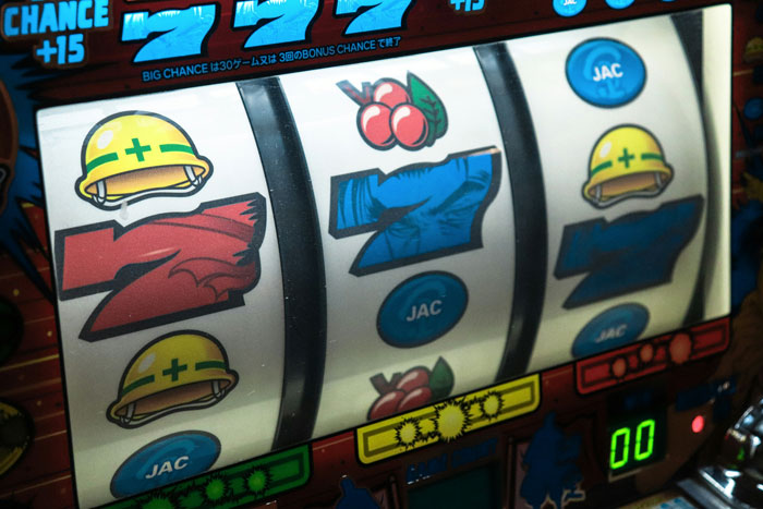 Slot machine showing winning combination after $500 raffle win.
