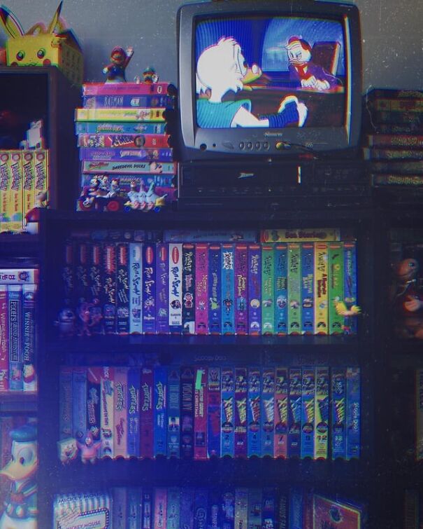 Retro finds include a CRT TV playing cartoons and shelves full of VHS tapes, evoking nostalgia and longing for past days.