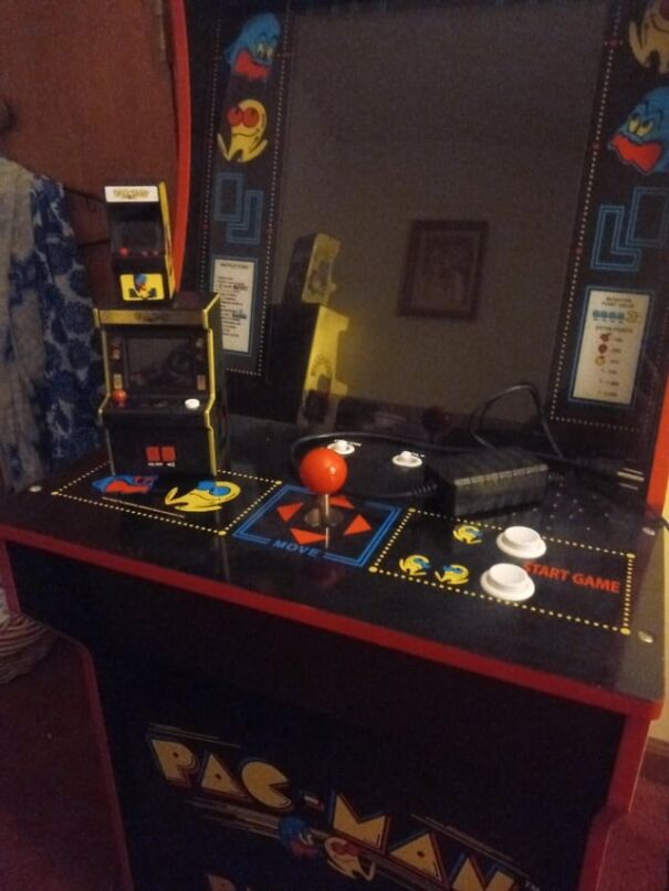 Retro arcade game machine featuring classic Pac-Man design with joystick and buttons.
