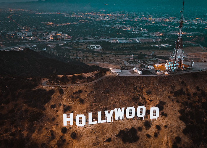 Aerial view of Hollywood sign overlooking one of the scariest cities at dusk.