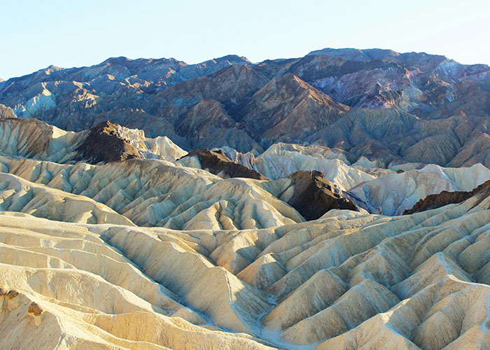 Arid, rugged desert landscape with colorful mountains, highlighting the eeriness of the scariest cities on earth.
