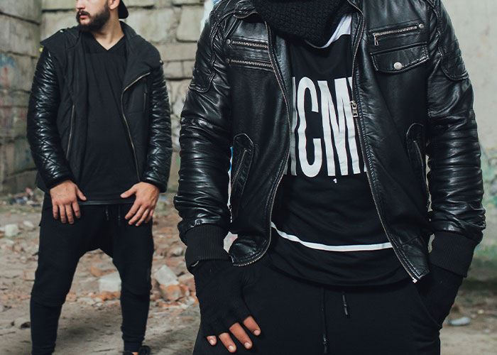 Two people in urban setting wearing black jackets, embodying a vibe of the scariest cities atmosphere.