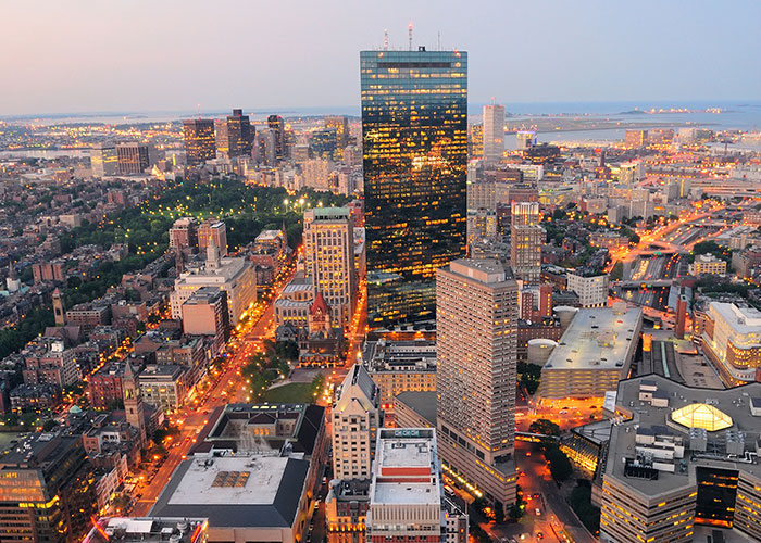 Aerial view of a cityscape with tall buildings and illuminated streets at dusk, symbolizing one of the scariest cities.