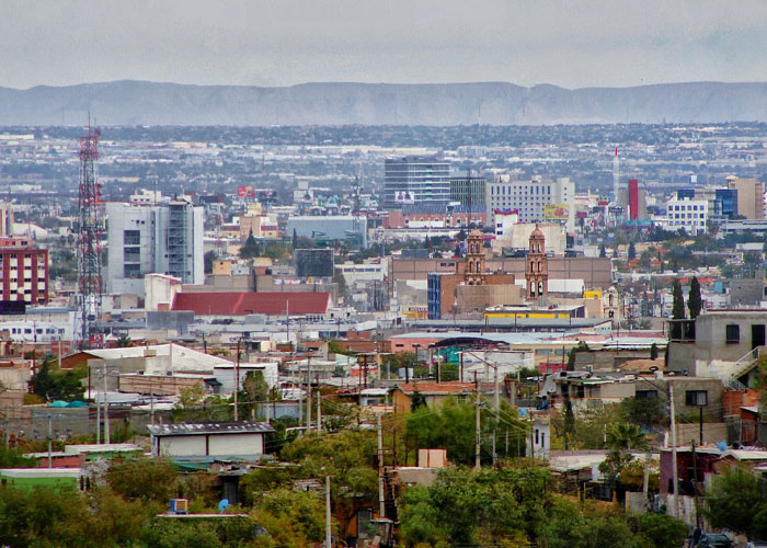 Cityscape view with mixed buildings, highlighting one of the scariest cities with a cloudy sky in the background.