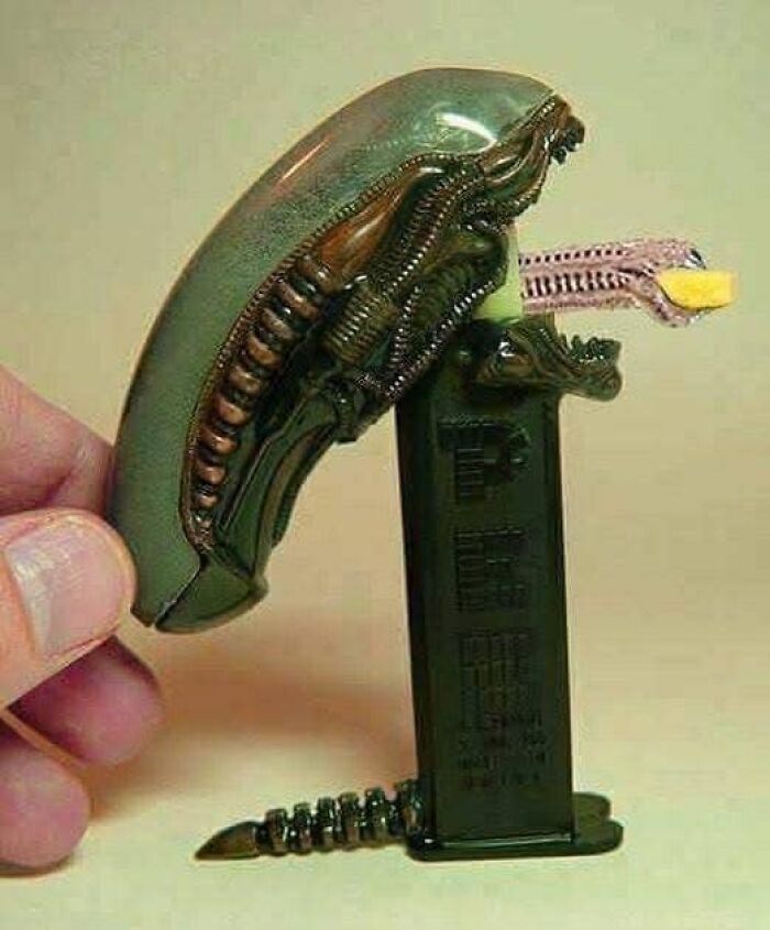 Science meme featuring an alien-themed candy dispenser with tongue holding a candy piece.