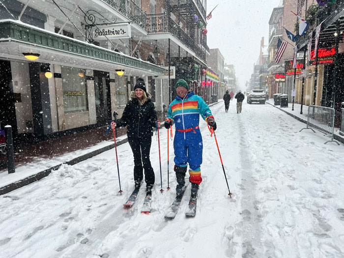 Southerners skiing down a snowy street during a once-in-a-lifetime snowstorm experience.