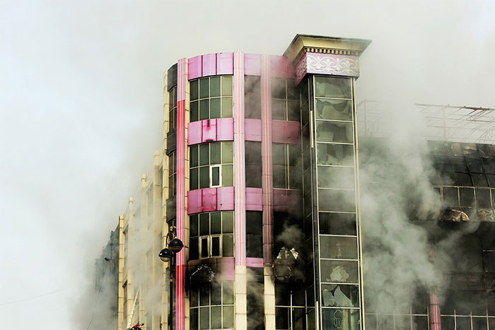Smoke billowing from a damaged building showing a rare moment captured in timestamped pictures of life-saving events.