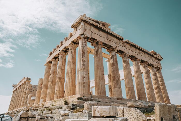 Ancient ruins under a clear blue sky, showcasing historical architecture in a debated travel destination.