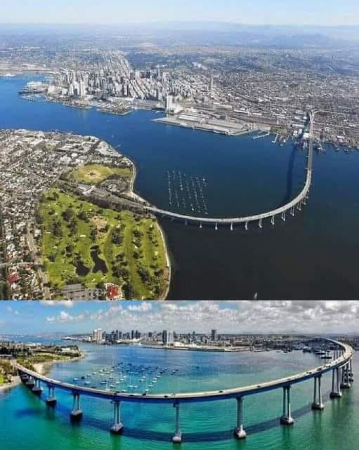 Aerial view of a long, curving bridge over water, with a city skyline in the background; fascinating architectural feat.