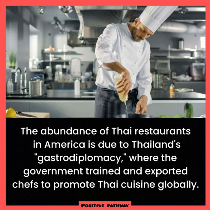 Chef in a kitchen preparing food, illustrating fascinating fact about gastrodiplomacy promoting Thai cuisine globally.