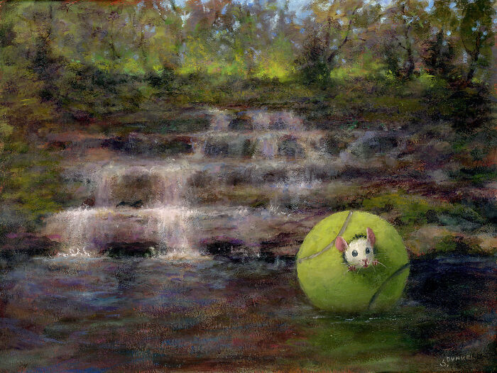 Mouse inside a tennis ball floating on a stream, with a waterfall in the background.