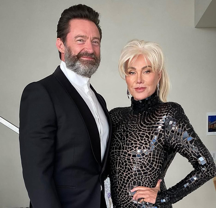 Deborra-Lee Furness posing together with Hugh Jackman indoors.