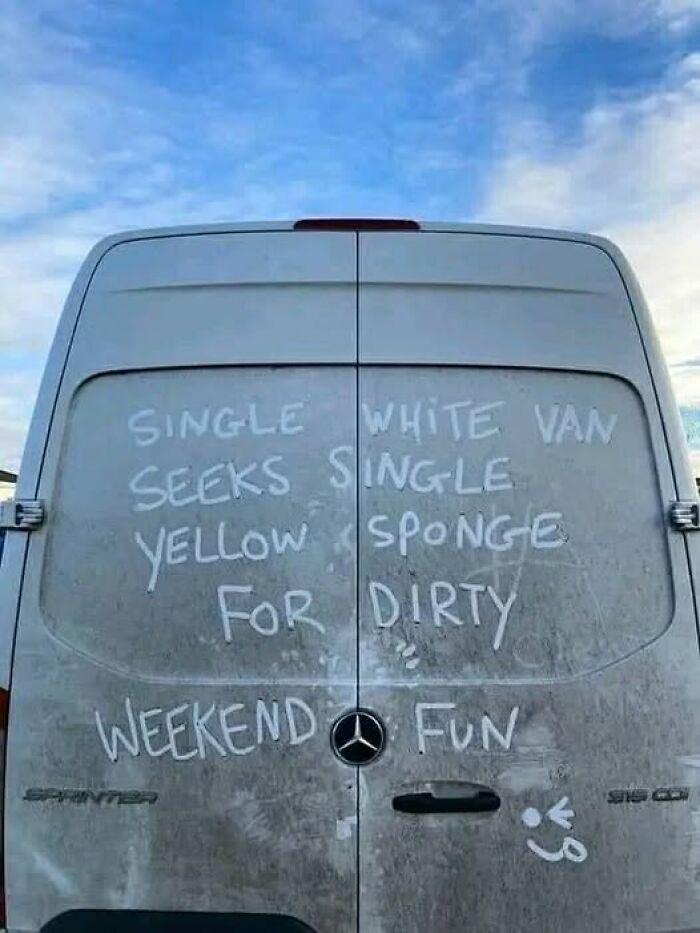 Dirty van with funny message written in dust, referencing a sponge for cleaning.