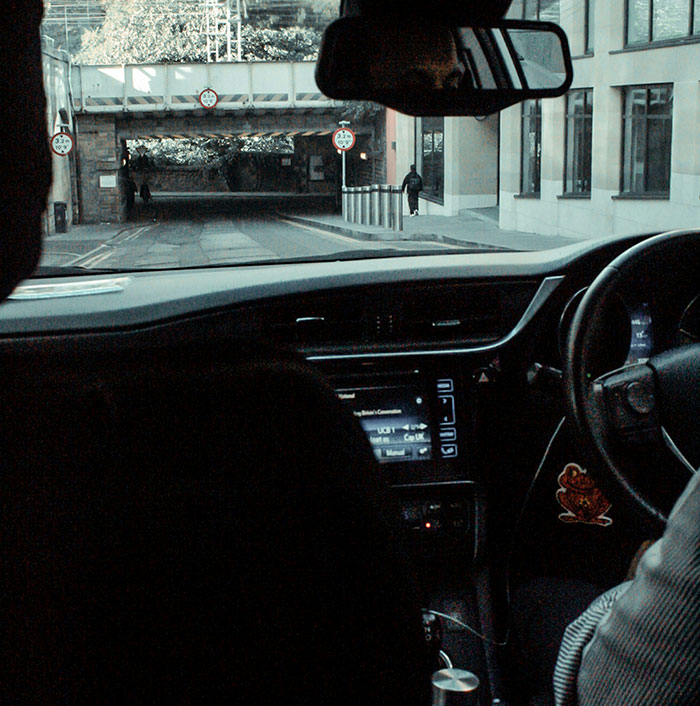 "Driving through a city tunnel, capturing a driver's perspective with rich people stories in the background."
