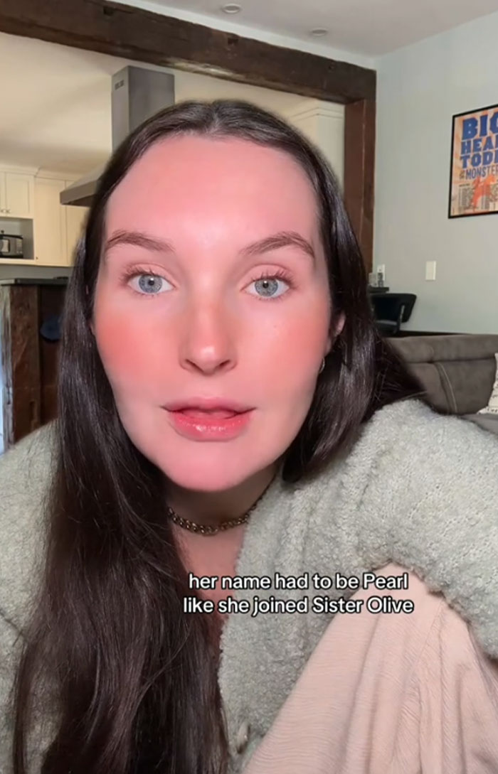 Woman discussing baby name Pearl for her dog in a casual indoor setting.