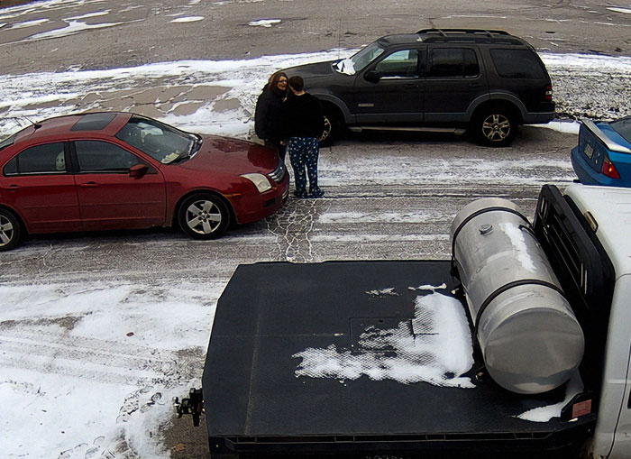 Road rage incident with two people standing between cars on a snowy street. Road rage incident with two people standing between cars on a snowy street.