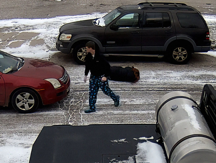 Person involved in viral road rage incident in snowy parking lot near parked cars. Person involved in viral road rage incident in snowy parking lot near parked cars.