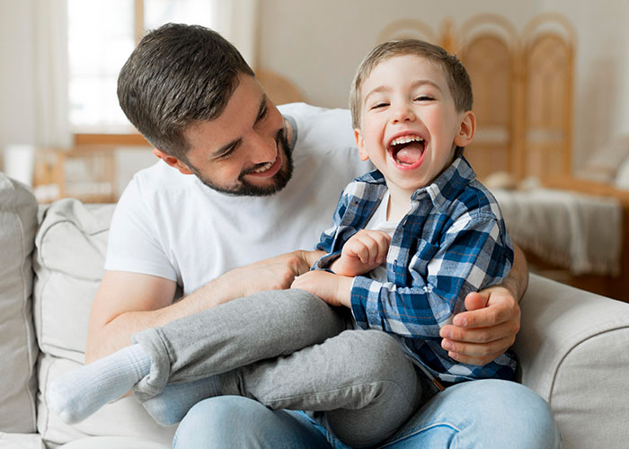 Man smiling with young child, highlighting custody choice amid complex family dynamics.