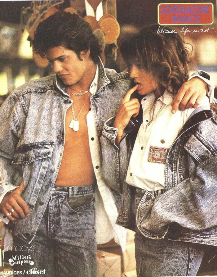80s fashion trends featuring a couple in matching denim jackets and jeans, embodying the iconic style of the decade.