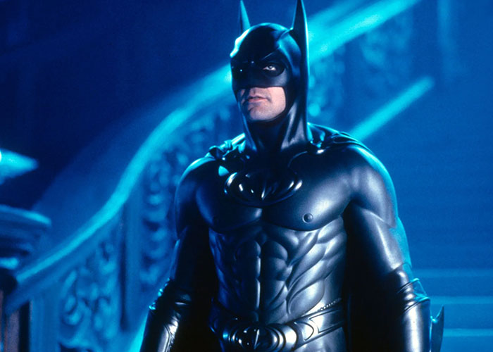 Actor in Batman costume on elaborate staircase; related to worst casting choice debate by film snobs.