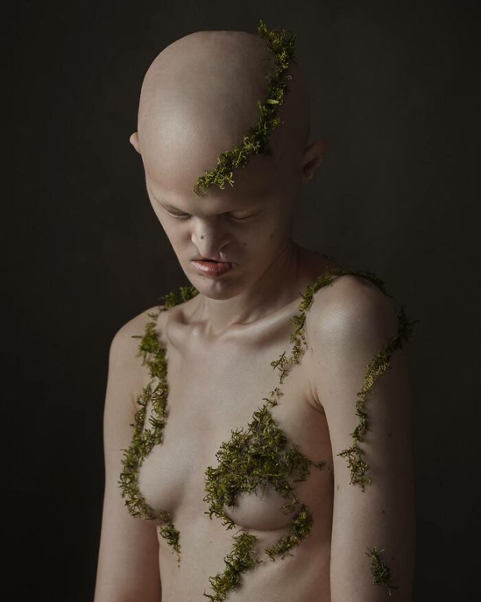 Unique model with green vines on skin, showcasing an artistic and compelling portrait.