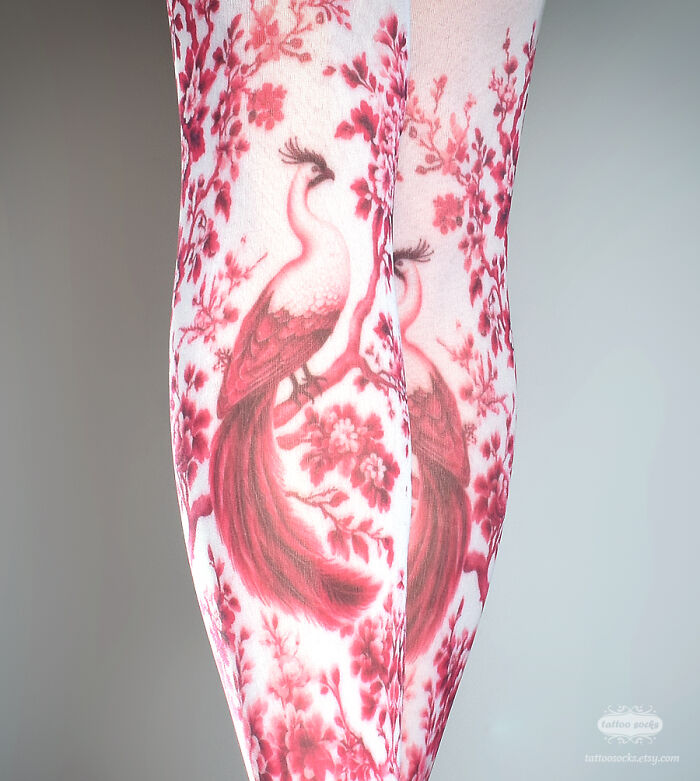 Unique tattoo tights with red peacock and floral design, showcasing intricate art.