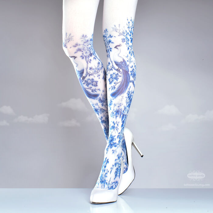 Unique tattoo tights with blue floral design and peacock motif, paired with white high heels.