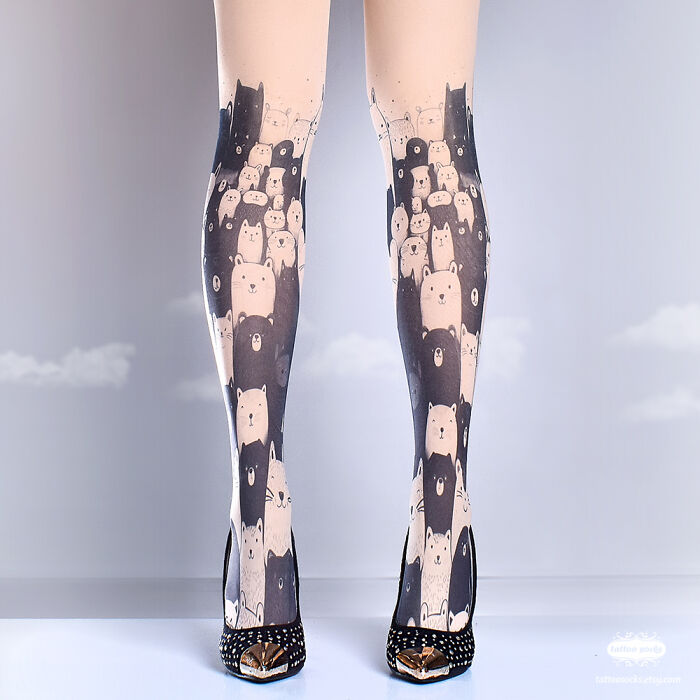 Tattoo tights featuring a cute bear pattern, worn with studded black heels against a soft, cloudy background.