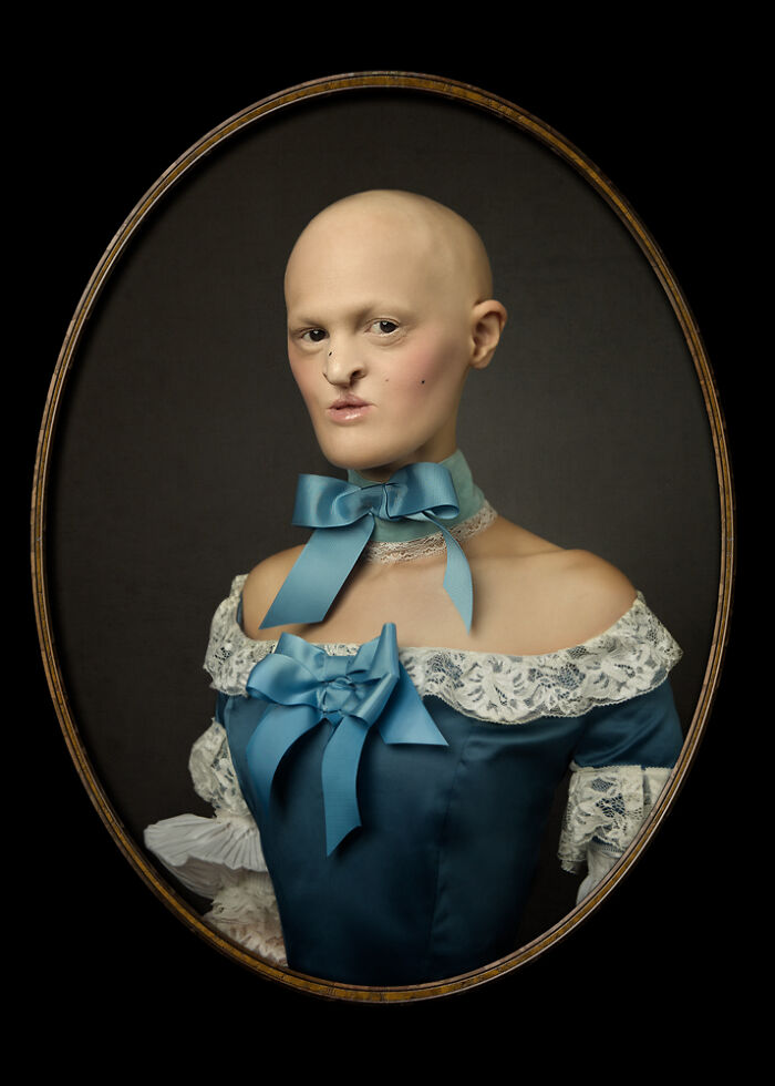 Unique model in a vintage blue dress with lace details and a blue ribbon choker.