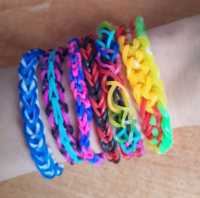 Colorful rubber band bracelets on wrist, similar to trends like using songs as ringtones.