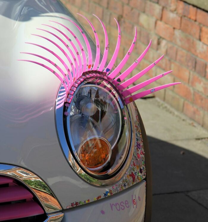 Car headlight with decorative pink eyelashes, symbolizing quirky trends similar to songs as ringtones.