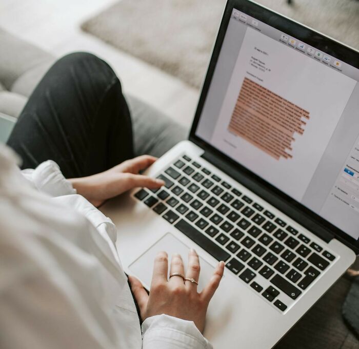 Person working on a laptop, possibly representing professions affected by industry changes.